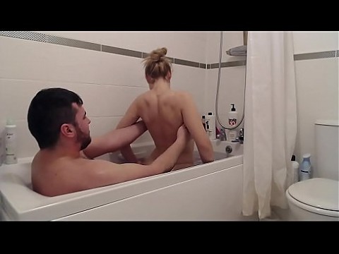 The step-sister entered her brother who was relaxing in the tub and entered with him in the hot water and began to suck his dick then he fucked her and gave cum on her face.